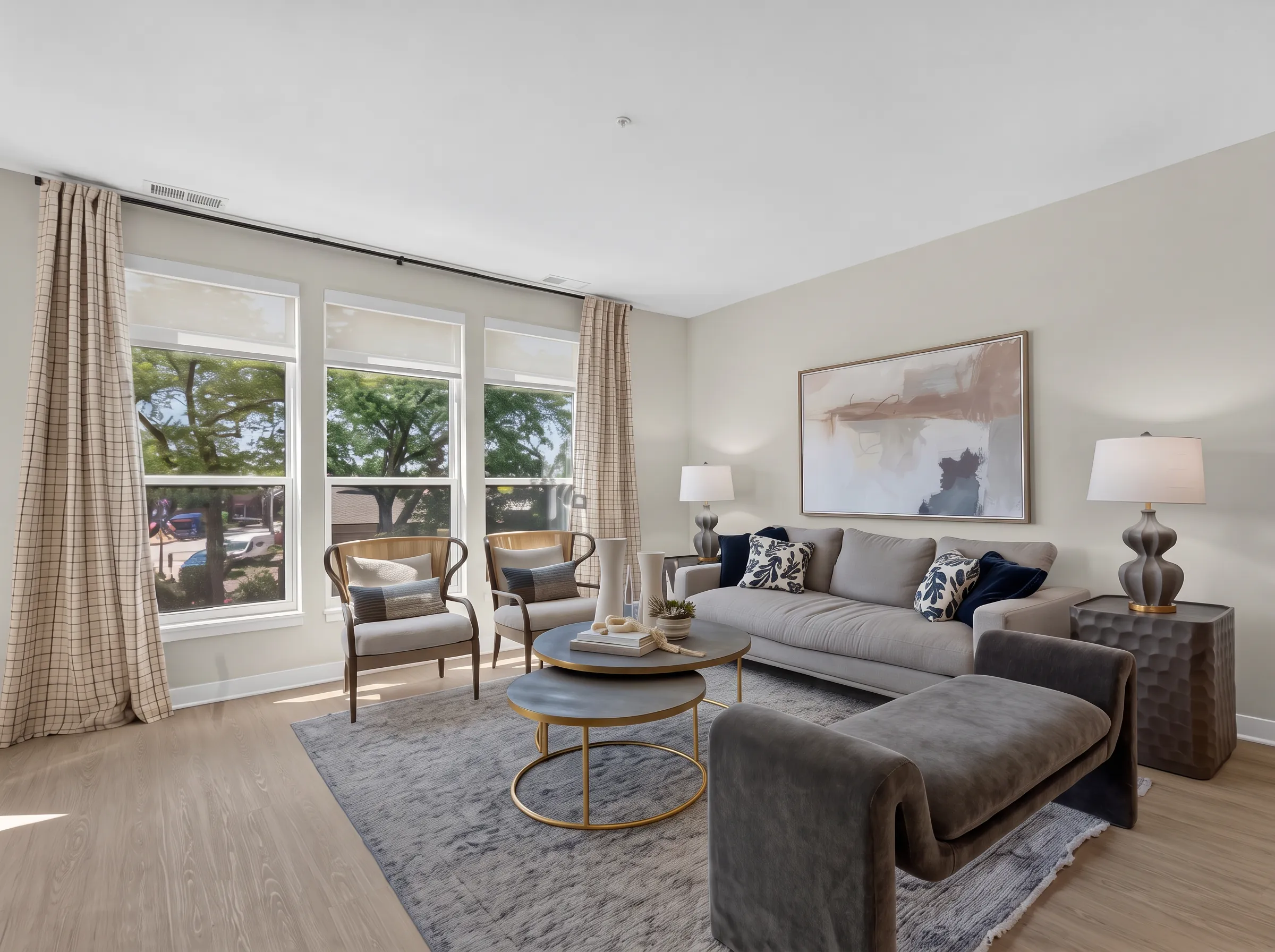 Real estate photography of a staged living room in a furnished one-bedroom apartment, shot by Ian K Captures
