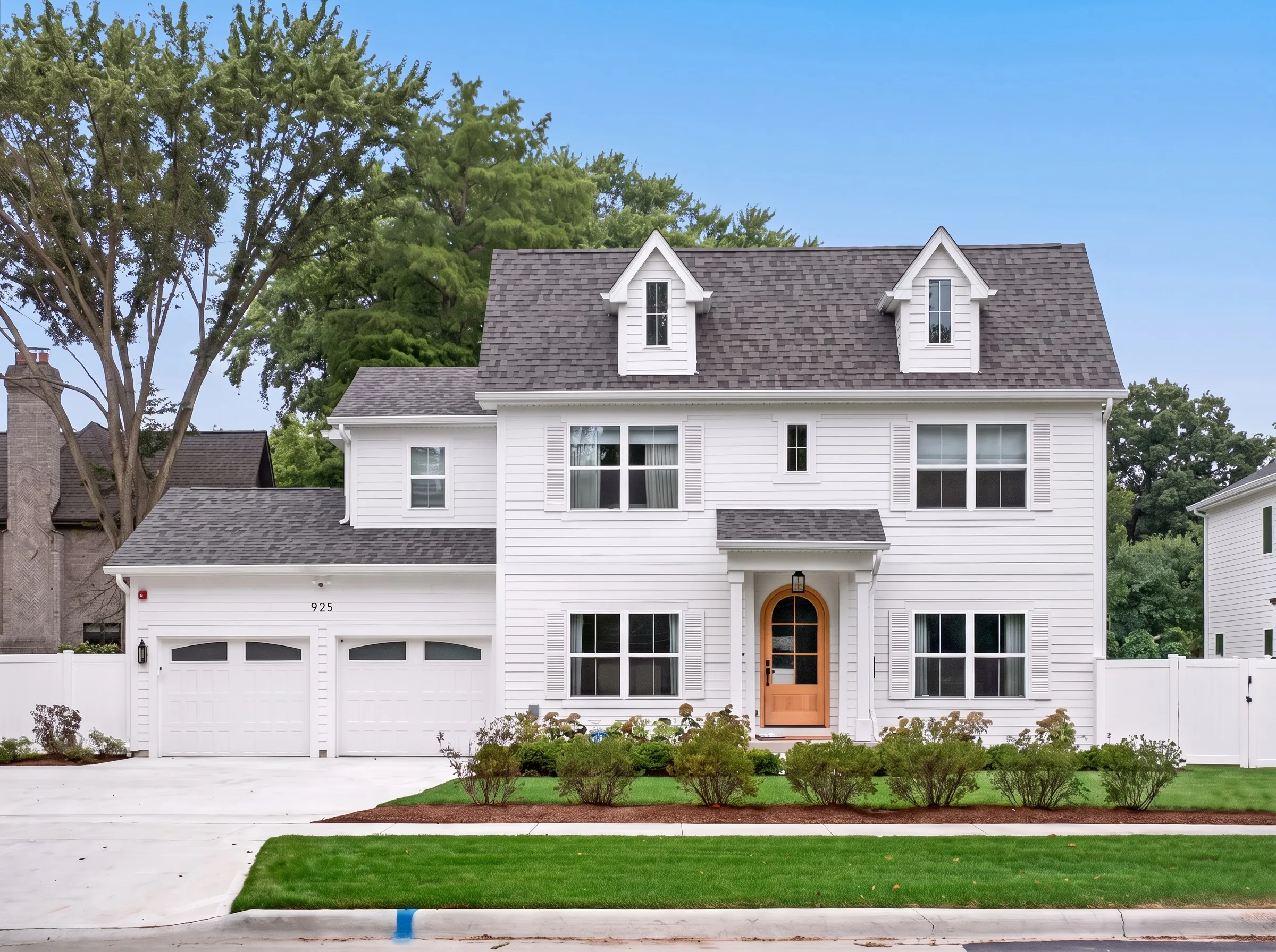 Daytime exterior photo of a white colonial home shot by Ian K Captures
