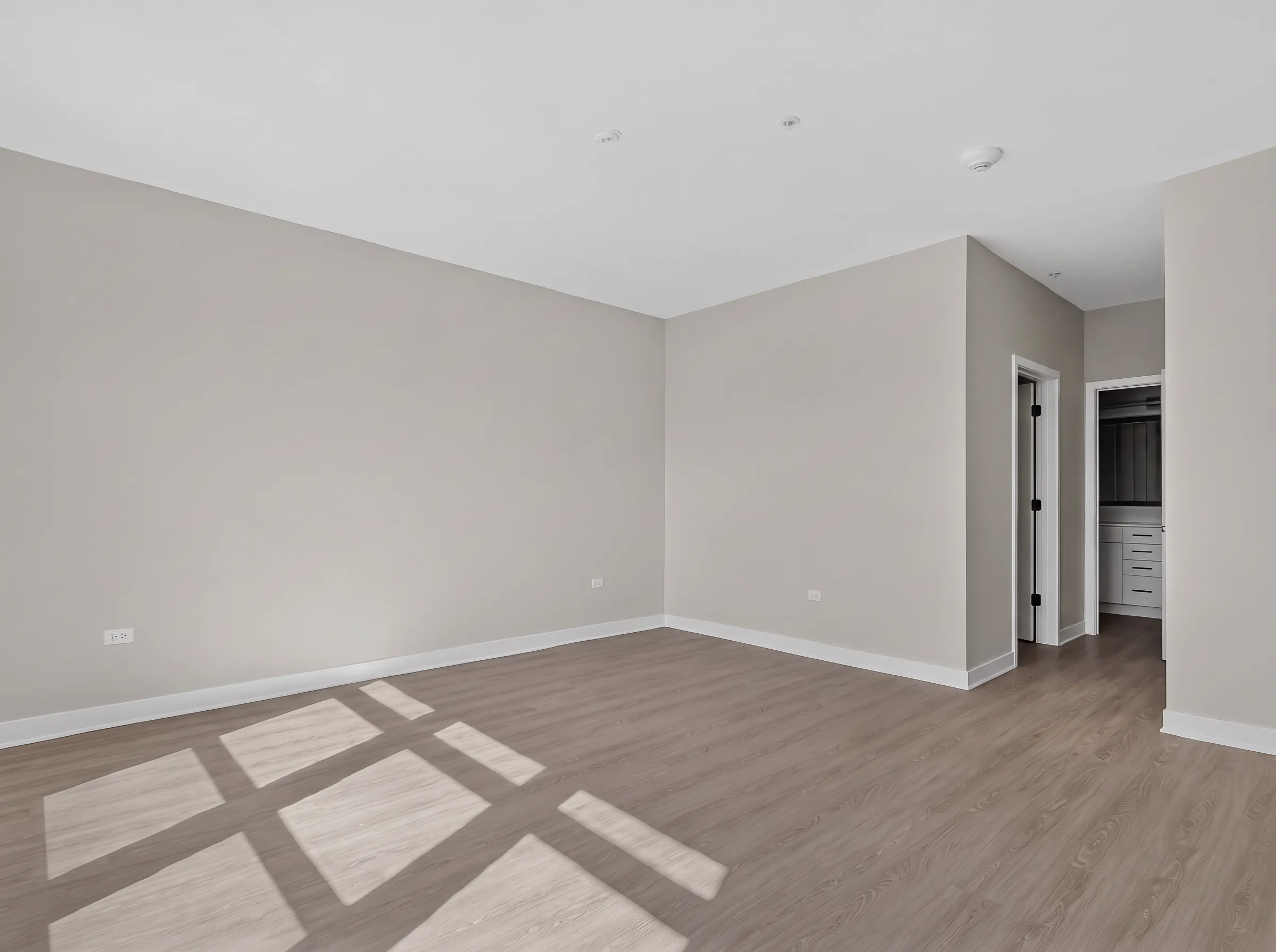 Real estate photography of a primary bedroom with natural light in a penthouse unit shot by Ian K Captures